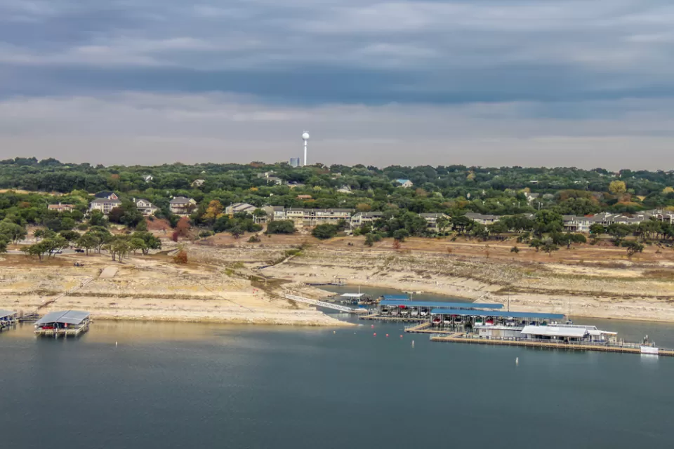 Lake TRavis is shown well below capacity, with the city of Austin in the background.